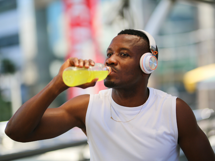 Man drinking water trying to hydrate after exercise